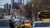 FILE - Pedestrians cross Delancey Street as congested traffic from Brooklyn enters Manhattan over the Williamsburg Bridge, March 28, 2019, in New York. Avoiding noise in New York City can be a daily struggle.