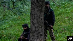 Indian soldiers keep guard near the site of attack on Sunil Kumar, a Kashmiri Hindu man, at Chotigam village, Indian-administered Kashmir, Aug. 16, 2022.