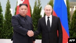 FILE - This picture released April 26, 2019, by North Korea's official Korean Central News Agency (KCNA) shows Russian President Vladimir Putin (R) and North Korean leader Kim Jong Un shaking hands a day earlier prior to their talks on Russky island in Russia's Far East.