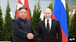 FILE - This picture released Apr. 26, 2019, by North Korea's official Korean Central News Agency (KCNA) shows Russian President Putin and N. Korean leader Kim Jong Un shaking hands a day earlier prior to their talks on Russky island. (Photo by KCNA via KNS / KCNA VIA KNS / AFP) 
