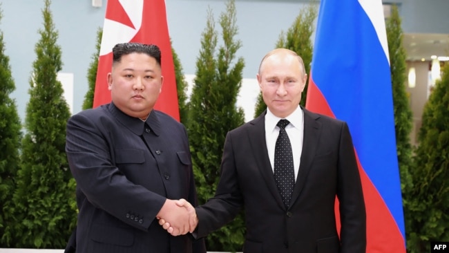 FILE - This picture released Apr. 26, 2019, by North Korea's official Korean Central News Agency (KCNA) shows Russian President Putin and N. Korean leader Kim Jong Un shaking hands a day earlier prior to their talks on Russky island. (Photo by KCNA via KNS / KCNA VIA KNS / AFP) 