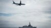 FILE - A Royal Australian Air Force P-8A Poseidon aircraft making a low pass over Royal Australian Navy destroyer HMAS Hobart during Fleet Certification Period, Feb. 24, 2022