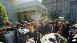 FILE - Soviet President Mikhail Gorbachev, center, is surrounded by reporters and cameras outside the White House in Washington, May 31, 1990, after his meeting with President Bush.