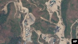 FILE - This 2022 satellite image provided by Planet Labs shows rare earth mining pools northwest of Myitkyina, Kachin, Myanmar near the border with China.