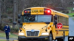 FILE - A Cobb County School bus March 13, 2020, in Kennesaw, Ga.