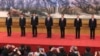 FILE - New members of the Politburo Standing Committee, from left, Han Zheng, Wang Huning, Li Zhanshu, Xi Jinping, Li Keqiang, Wang Yang, Zhao Leji stand together on Oct. 25, 2017, the day after the end of the 19th Communist Party Congress. 