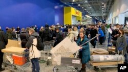 FILE - People wait in a line to pay for purchases at the IKEA store on the outskirts of Moscow, Russia, on March 3, 2022.