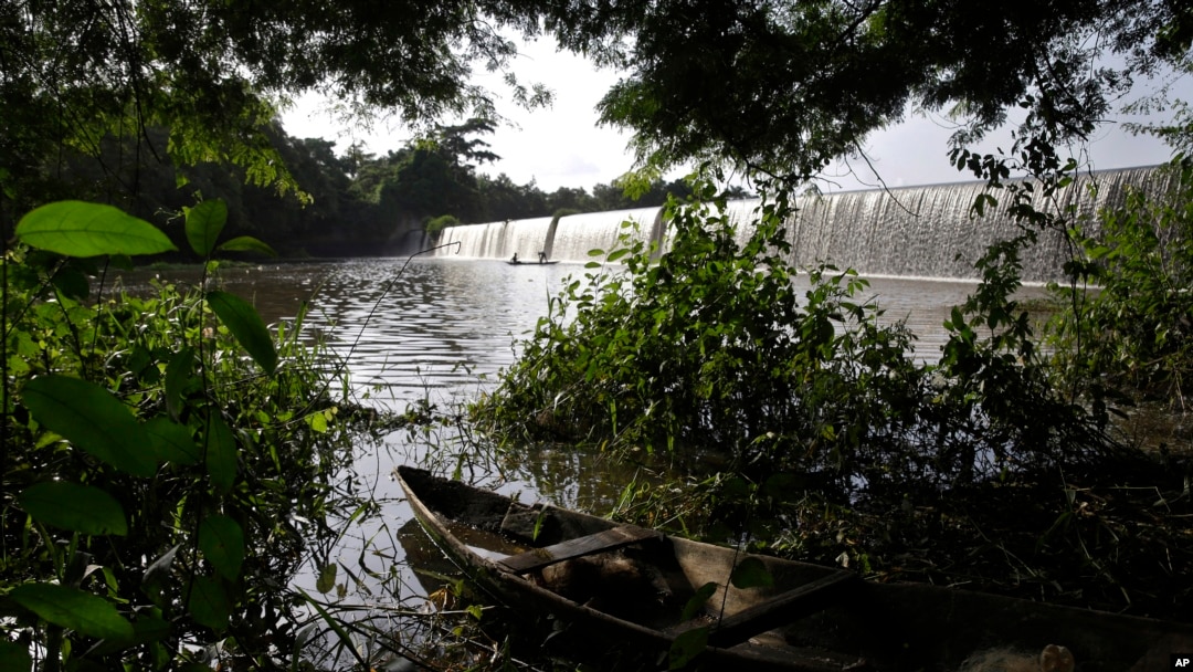 A fishing canoe sits near a dam that sources the sacred Osun River in Esa-Odo, Nigeria, on May 28, 2022.