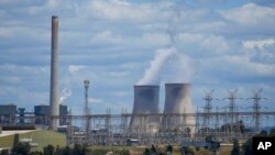 FILE - The Liddell Power Station, left, and Bayswater Power Station, coal-powered thermal power stations, are pictured near Muswellbrook in the Hunter Valley, Australia, Nov. 2, 2021. 