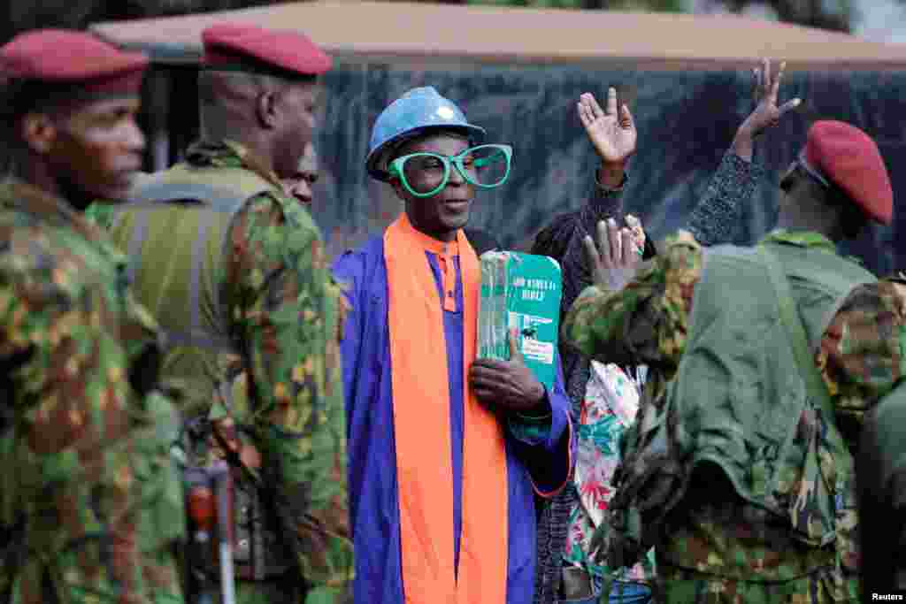 Police officers stand guard as supporters of Kenya&#39;s opposition leader and presidential candidate Raila Odinga of the Azimio La Umoja (Declaration of Unity) One Kenya Alliance, gather while his legal team prepares to file a petition challenging the presidential election result at the Supreme Court in Nairobi.