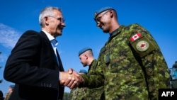 NATO Secretary-General Jens Stoltenberg meets with members of the Canadian armed forces at the Royal Canadian Air Force base in Cold Lake, Alberta, Aug. 26, 2022. (NATO handout)