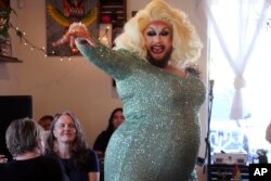 Emcee Golden Delicious performs before a mock election at Cafecito Bonito in Anchorage, Alaska, where people ranked the performances by drag performers, July 28, 2022.