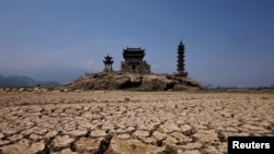 Pagodas are seen on Louxingdun island that usually remain partially submerged under the water of Poyang Lake, which is facing low water levels due to a regional drought in Lushan, Jiangxi province, China.