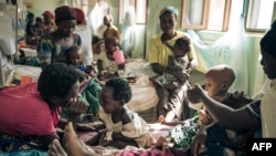 Des femmes déplacées par la guerre nourrissent et jouent avec leurs enfants à l'hôpital de Rutshuru, dans la province orientale du Nord-Kivu, le 22 juillet 2022.