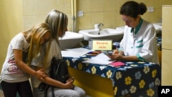 People receive iodine tablets at a distribution point in Zaporizhzhia, Ukraine, Aug. 26, 2022.