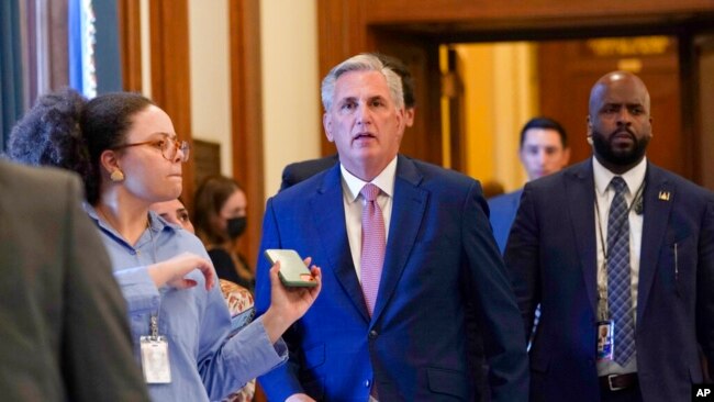 House Minority Leader Kevin McCarthy of California is followed by a reporter as he walks to his office on Capitol Hill in Washington, Aug. 12, 2022.