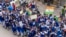 Schoolchildren walk waving the national flag ahead of India's Independence Day in Prayagraj, in northern Indian state of Uttar Pradesh, Wednesday, Aug 10, 2022. India will celebrate its 75th Independence Day anniversary on Aug. 15.
