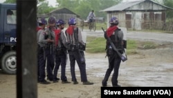 Border Guard Police stand at edge of Sittwe IDP camp in August 2017, a few days after the start of the clearance operation.