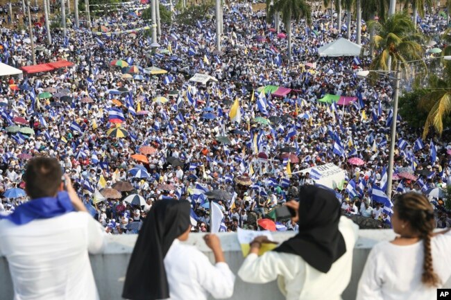 FILE - Thousands of people congregate outside Managua's Cathedral during a "Peace and Justice" rally called by the Catholic Church, in Managua, Nicaragua, April 28, 2018. (AP Photo/Alfredo Zuniga, File)