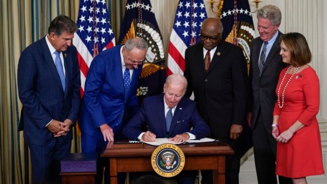 President Joe Biden signs the Democrats' landmark climate change and health care bill in the State Dining Room of the White House in Washington, Aug. 16, 2022.