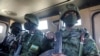 FILE - Soldiers from the Rwandan security forces sit inside an Armored Personal Carrier near the Afungi natural gas site, Mozambique, Sept. 22, 2021. 