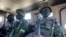 FILE - Soldiers from the Rwandan security forces sit inside an Armored Personal Carrier (APC) near the Afungi natural gas site, Mozambique, Sept. 22, 2021. 