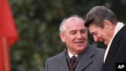 FILE - U.S. President Ronald Reagan, right, talks with Soviet leader Mikhail Gorbachev during arrival ceremonies at the White House where the superpowers held summit talks in Washington, D.C., Dec. 8, 1987. 