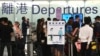 FILE - Passengers line up at a check-in counter at Hong Kong International Airport, April 1, 2022.