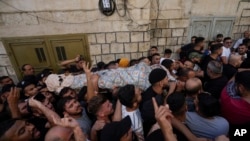 Palestinians carry the body of Islam Sabouh, who was killed during an operation by Israeli forces in the West Bank city of Nablus, Aug. 9, 2022.