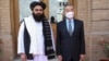 FILE - In this photo released by Xinhua News Agency, Chinese Foreign Minister Wang Yi poses for pictures with Amir Khan Muttaqi, acting foreign minister of the interim government of the Afghan Taliban, in Kabul, March 24, 2022. (Saifurahman Safi/Xinhua via AP)