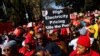 South Africans carry placards during a nationwide strike over the high cost of living, in Pretoria, South Africa, Aug. 24, 2022. 