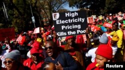 FILE: In a previous South Africa labor action, workers carry placards during a nationwide strike over the high cost of living, in Pretoria, South Africa, Aug. 24, 2022. 