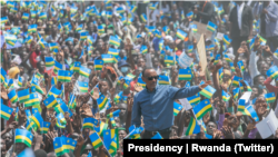 President Paul Kagame of Rwanda stands amid a cheering crowd in Ruhango district southern Rwanda