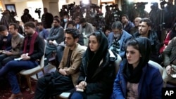 FILE - Afghan Journalists attend a press conference of a former president Hamid Karzai in Kabul, Afghanistan, Feb. 13, 2022.
