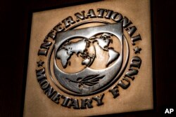 FILE - The logo of the International Monetary Fund is visible on its building, April 5, 2021, in Washington.