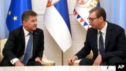 In this photo provided by the Serbian Presidential Press Service, Serbian President Aleksandar Vucic, right, speaks with European Union envoy Miroslav Lajcak in Belgrade, Serbia, Aug. 25, 2022.
