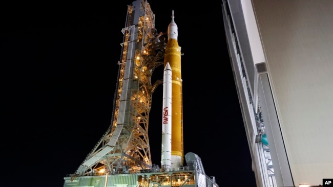 The NASA Artemis rocket with the Orion spacecraft aboard leaves the Vehicle Assembly Building moving slowly to pad 39B at the Kennedy Space Center in Cape Canaveral, Fla., Tuesday, Aug. 16, 2022. (AP Photo/Terry Renna)