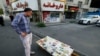 A man looks at a newspaper stall with a view of Etemad newspaper's front page bearing a title reading in Farsi 'The night of the end of the JCPOA ', in the capital Tehran on Aug. 16, 2022.