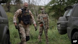 Volunteer soldiers attend training near Kyiv, Ukraine, Aug. 27, 2022. Some volunteers signed up to join a Chechen unit that fights alongside the Ukrainian military.