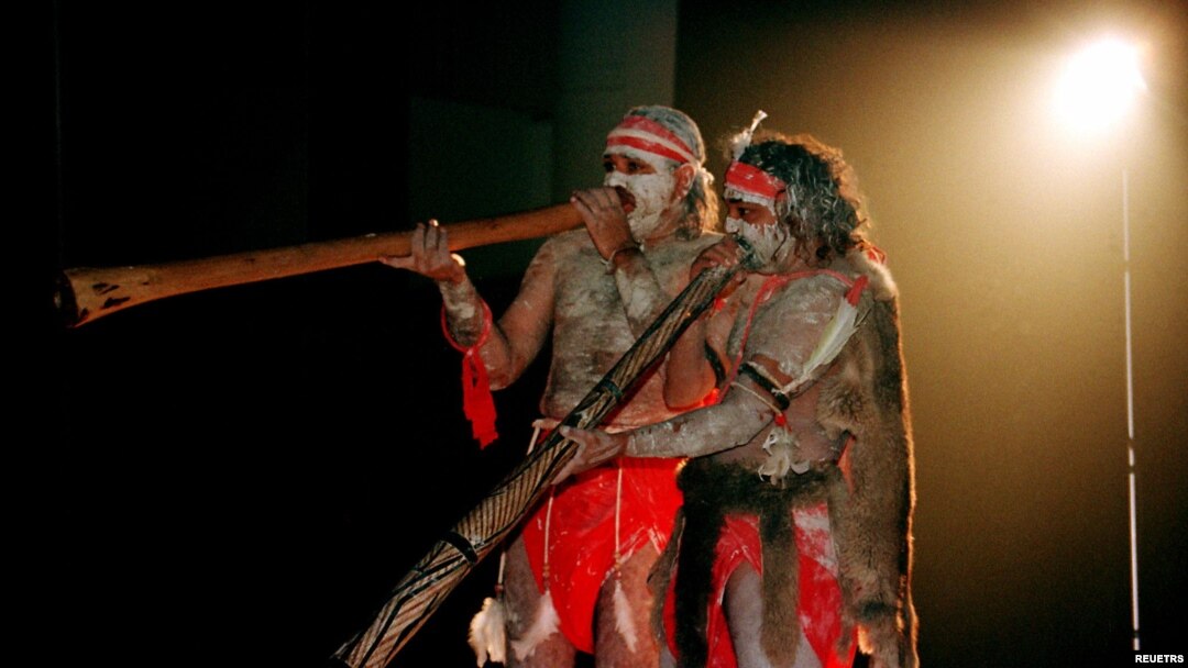 FILE- Two Aboriginal performers painted in traditional colors play the 'Didjiridoo' aboriginal instrument at the 'Festival of the Dreaming' in Sydney. Some events will showcase Indigenous languages and traditional dance steps not seen by non-Aboriginal people in nearly 200 years.