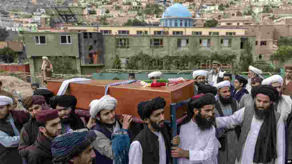 Mourners carry the body of a victim of Wednesday&#39;s mosque bombing in Kabul, Afghanistan, that killed at least 10 people and injured 12.(AP Photo/Ebrahim Noroozi)