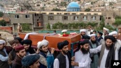 Mourners carry the body of a victim of Wednesday&#39;s mosque bombing in Kabul, Afghanistan, that killed at least 10 people and injured 12.(AP Photo/Ebrahim Noroozi)