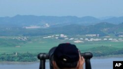 FILE - A visitor watches the North Korea side from the Unification Observation Post in Paju, South Korea, near the border with North Korea, July 30, 2022.