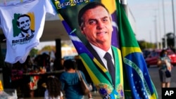 FILE - A banner emblazoned with an image of Brazil's President Jair Bolsonaro, who is a candidate for reelection, is displayed for sale in Brasilia, Brazil, Aug. 2, 2022. 