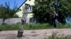 FILE - An emptied cluster munition container is seen stuck in the ground following a military strike, amid Russia's attack on Ukraine, on the outskirts of Kharkiv, Ukraine, June 10, 2022.