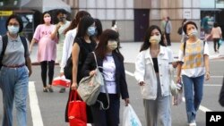People wear face masks to protect against the spread of the coronavirus in Taipei, Taiwan, Aug. 31, 2022.