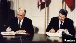 FILE - U.S. President Ronald Reagan and Soviet President Mikhail Gorbachev sign the Intermediate-Range Nuclear Forces treaty in Washington, Dec. 8 1987. Russian President Vladimir Putin wants to resume production of intermediate- and shorter-range nuclear-capable missiles.