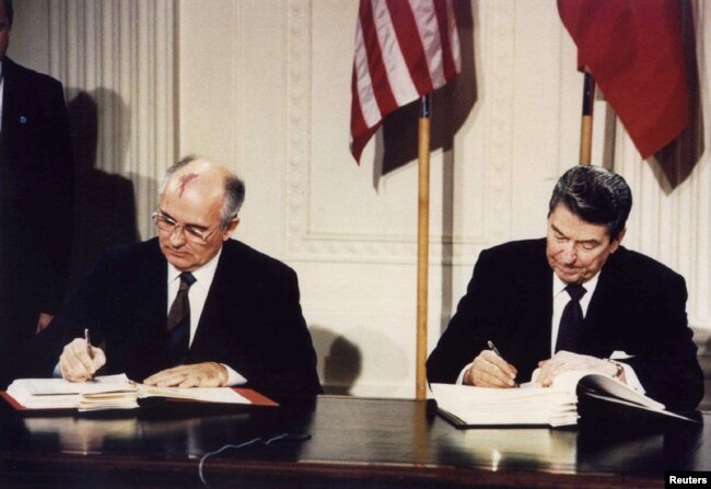 FILE - U.S. President Ronald Reagan, right, and Soviet President Mikhail Gorbachev signing the Intermediate-Range Nuclear Forces treaty at the White House, Washington, on Dec. 8 1987. (REUTERS/Dennis Paquin/File Photo)