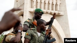 FILE - Malian army soldiers are seen at the Independence Square after a mutiny, in Bamako, Mali Aug. 18, 2020.
