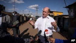 Sen. Chris Coons, leading a U.S. congressional delegation, speaks to The Associated Press in the Kibera neighborhood of Nairobi, Kenya, Aug. 18, 2022.